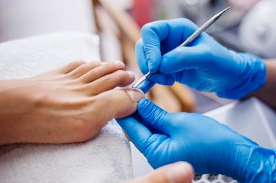 pedicure-process-home-salon-pedicure-foot-care-treatment-nail-process-professional-pedicures-master-blue-gloves-make-pedicure_343596-1589.jpg